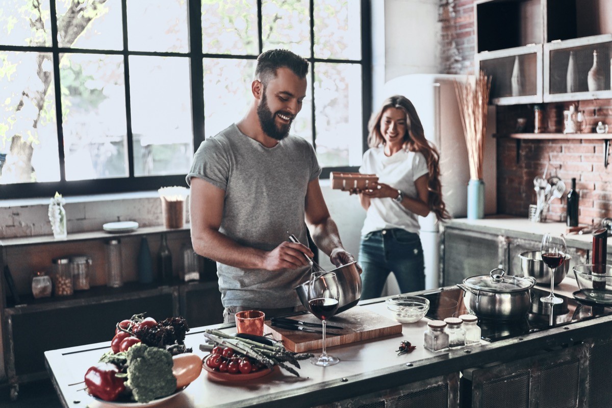 couple cooking in kitchen