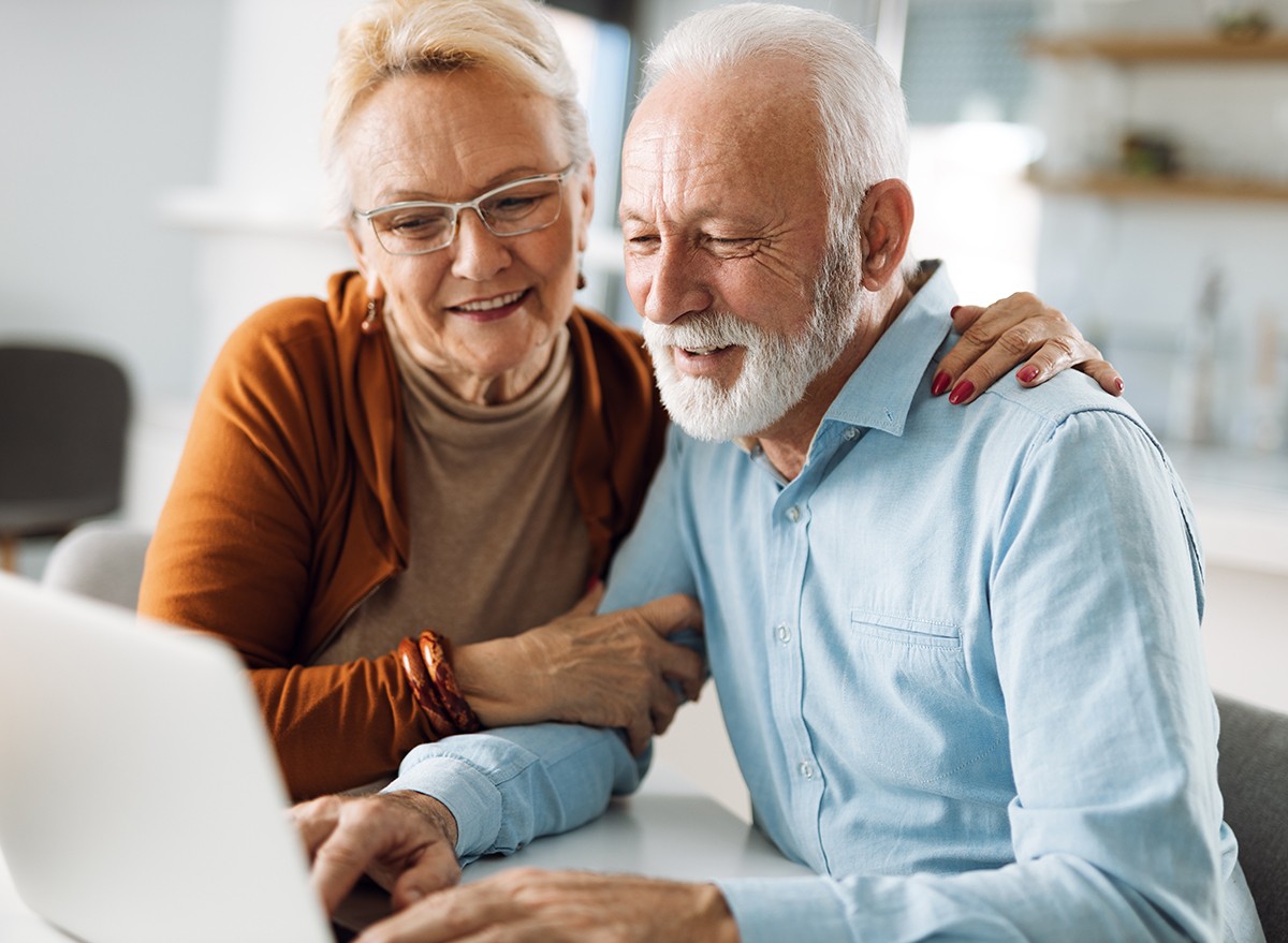 A senior couple compare providers online