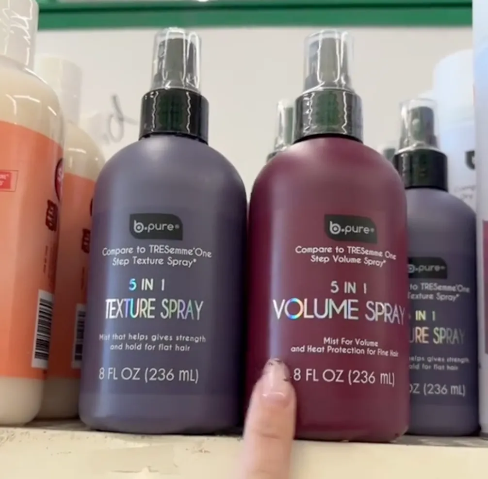 shopper pointing to hair sprays at Dollar Tree