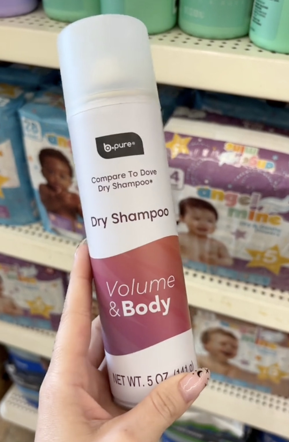 shopper holding up dry shampoo at Dollar Tree