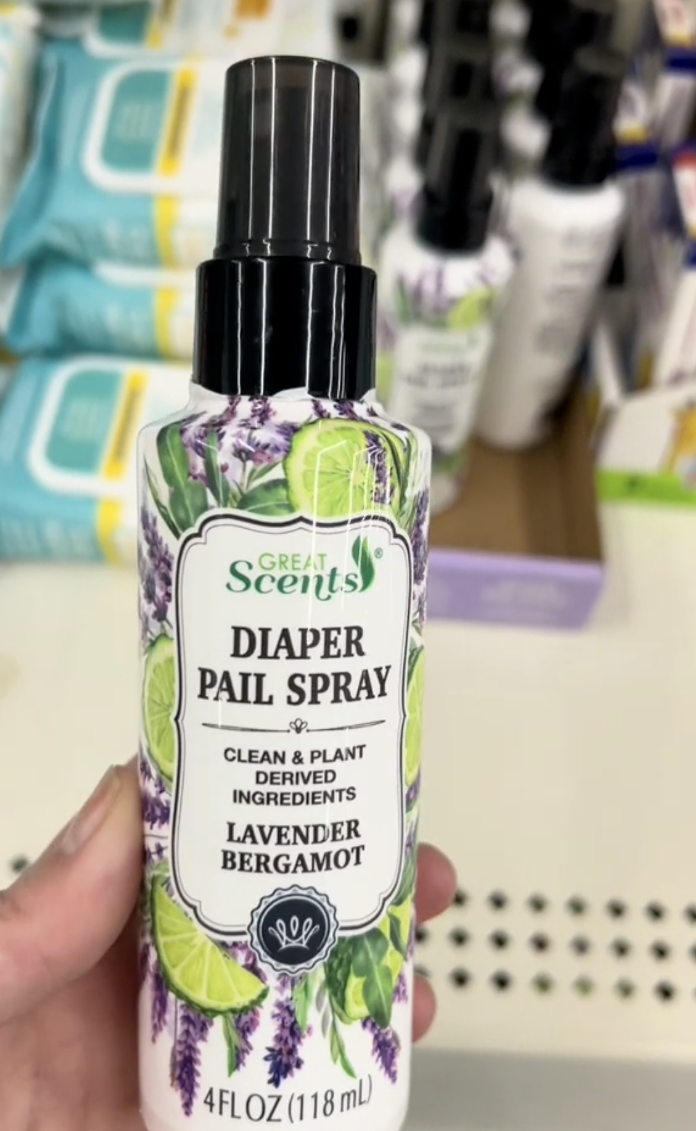 shopper holding up toilet spray at Dollar Tree