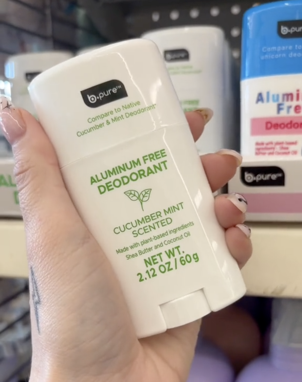 shopper holding up aluminum-free deodorant at Dollar Tree