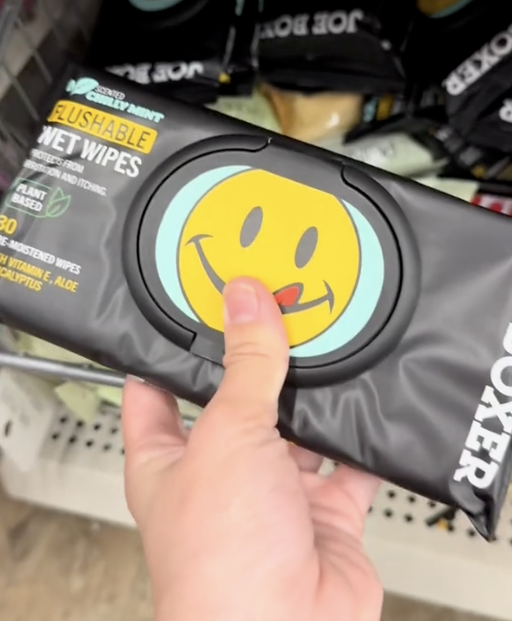shopper holding up moist wipes at Dollar Tree