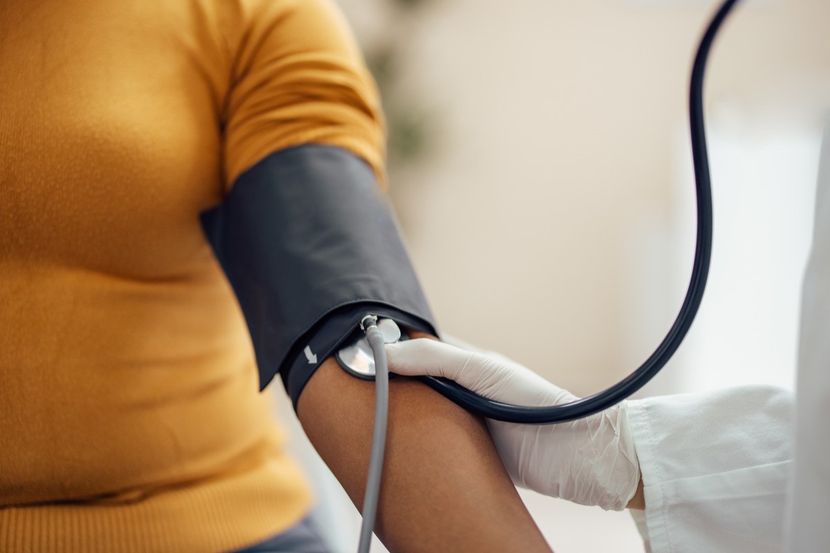 A doctor measuring a woman's blood pressure