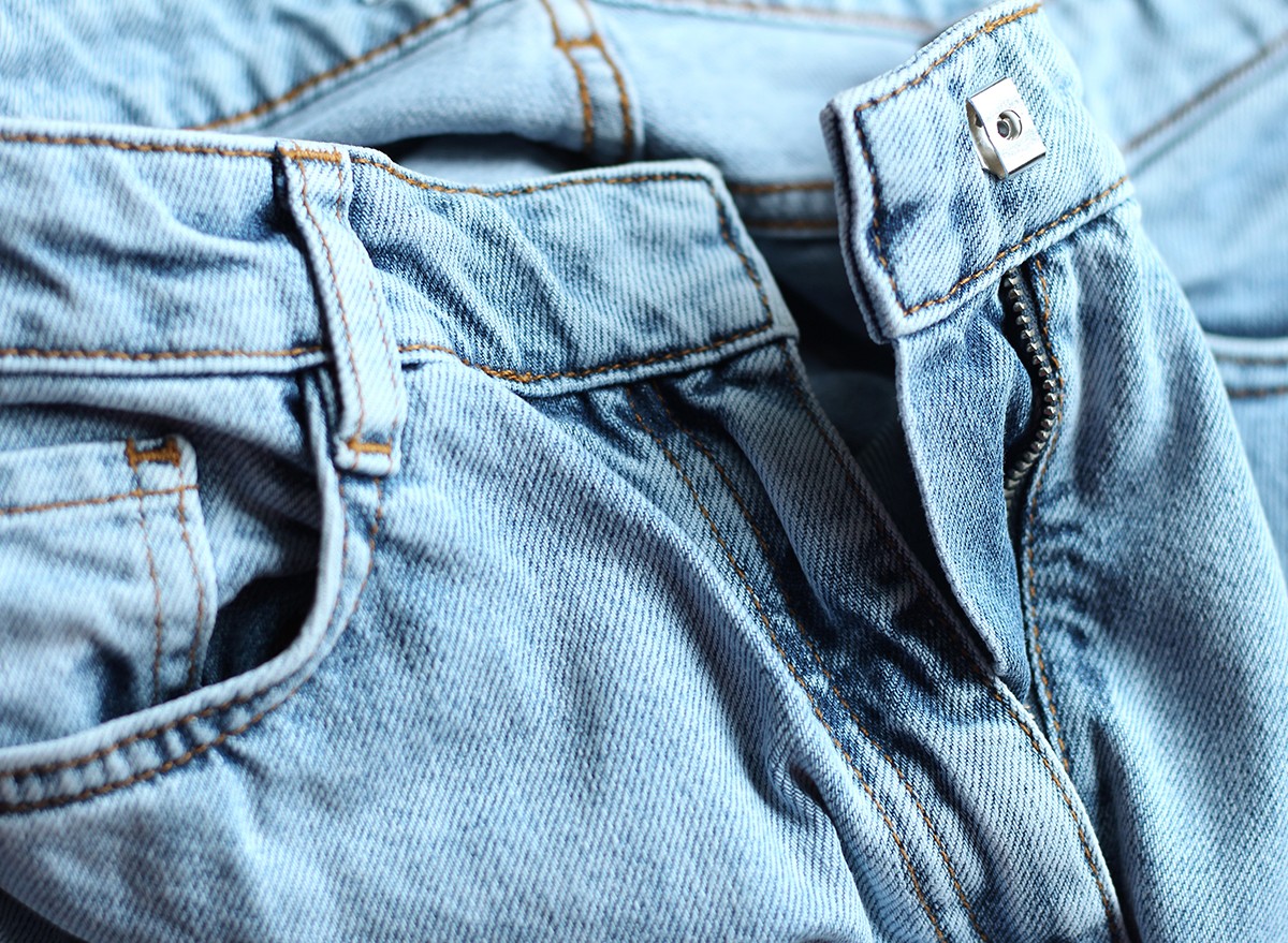 A pair of blue jeans with the zipper undone