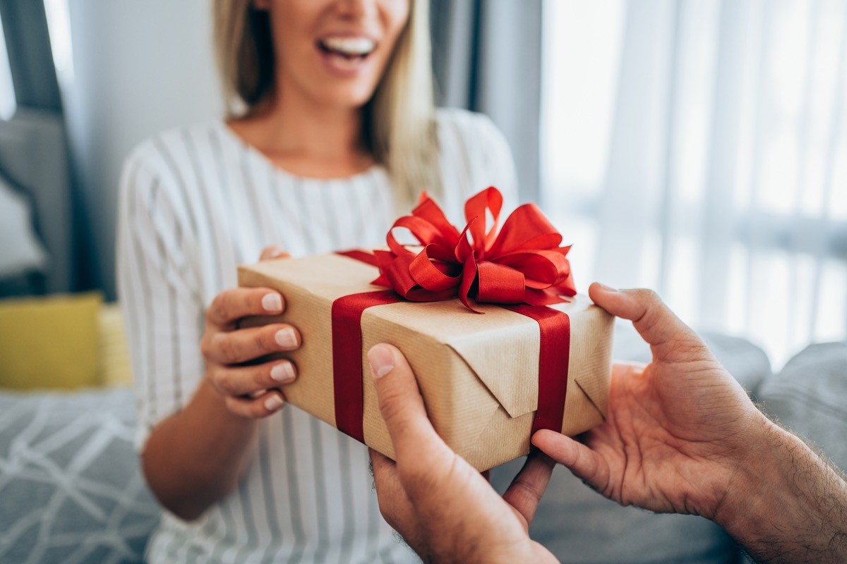 Cropped shot of a man giving a woman a gift
