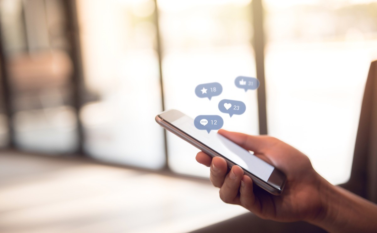 hand using smart phone with Social media