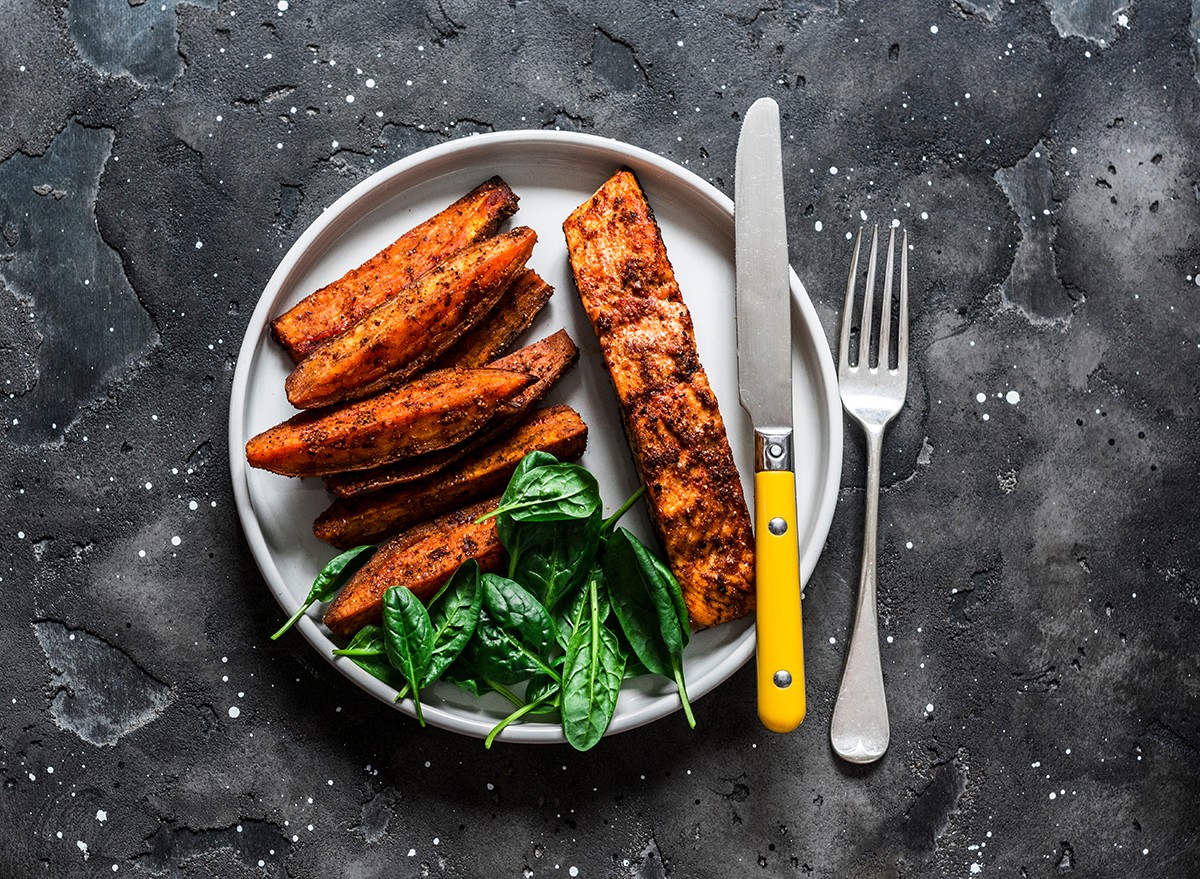 A plate with salmon, sweet potatoes and spinach