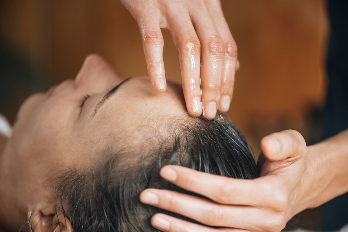 closeup of a woman enjoying a scalp massage