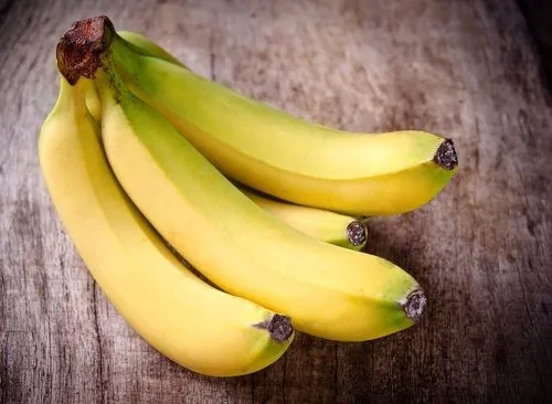 Bananas on a wood background.