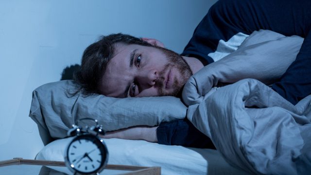 Sleepless man awake at night not able to sleep
