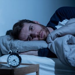 Sleepless man awake at night not able to sleep
