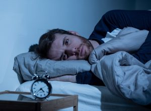 Sleepless man awake at night not able to sleep