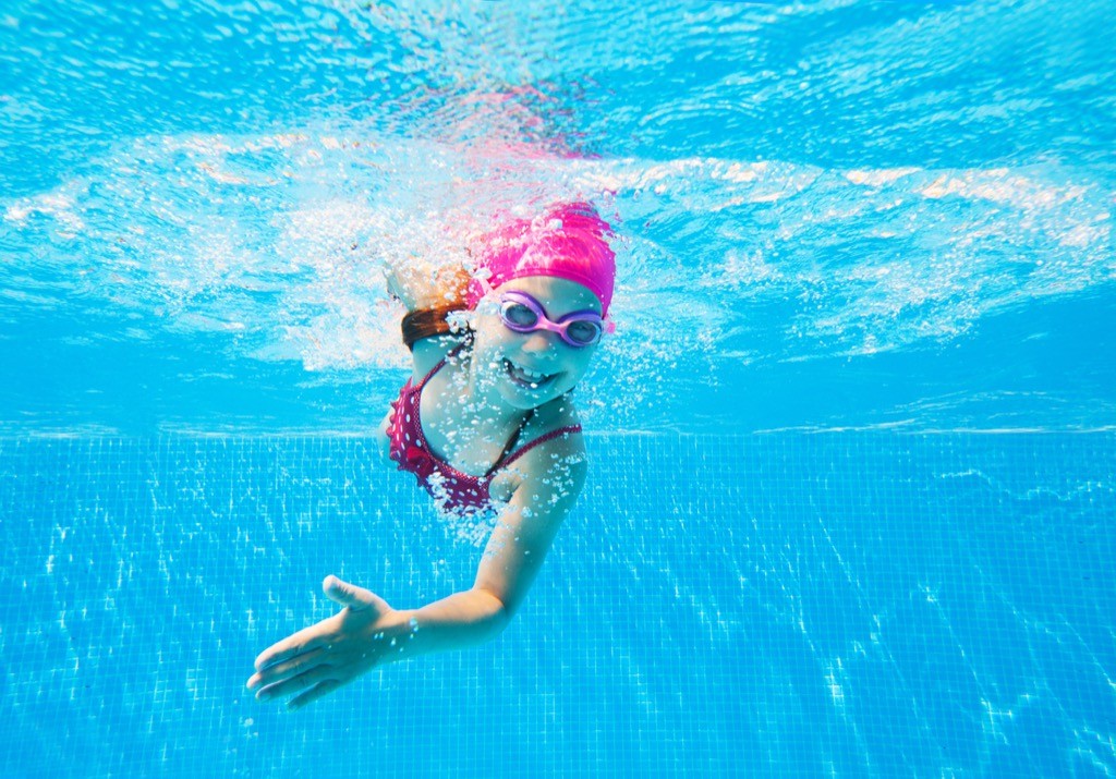 A little girl swimming in a pool