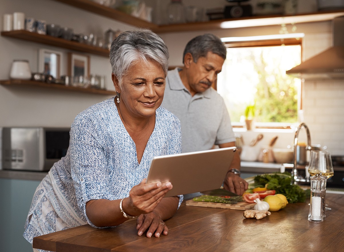 A mature couple cooking in the kitchen together