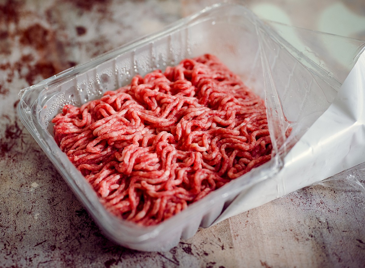 An open package of raw meat on a work surface