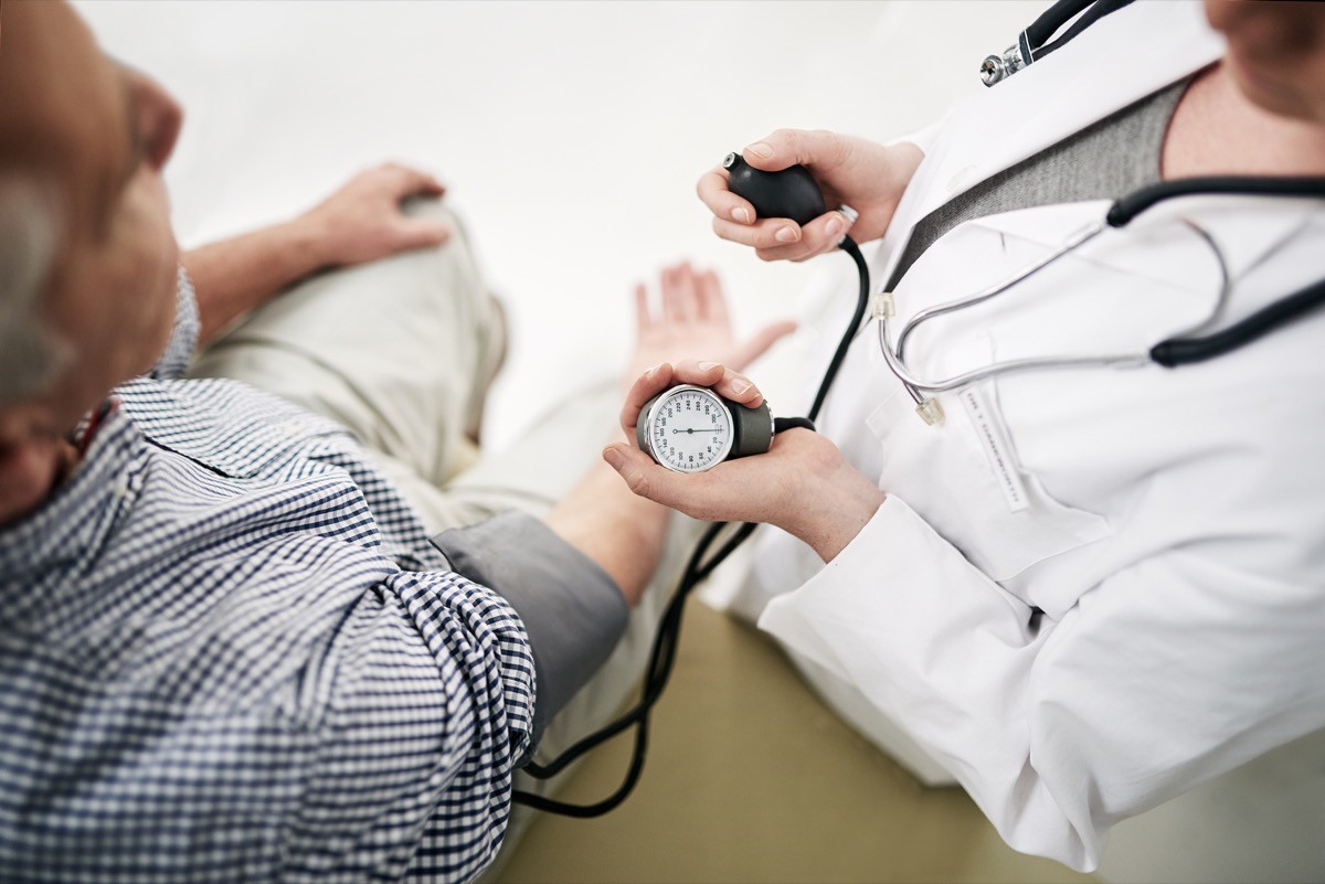 Shot of a doctor checking a patient's blood pressure in her office