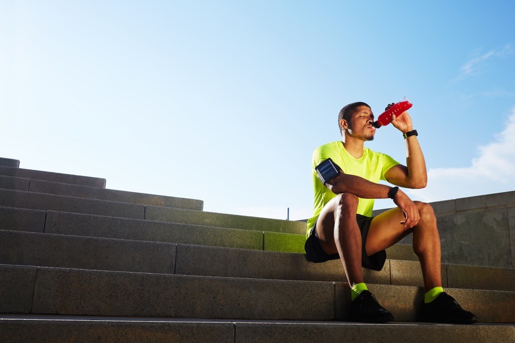 Man drinking a sports drink after working out