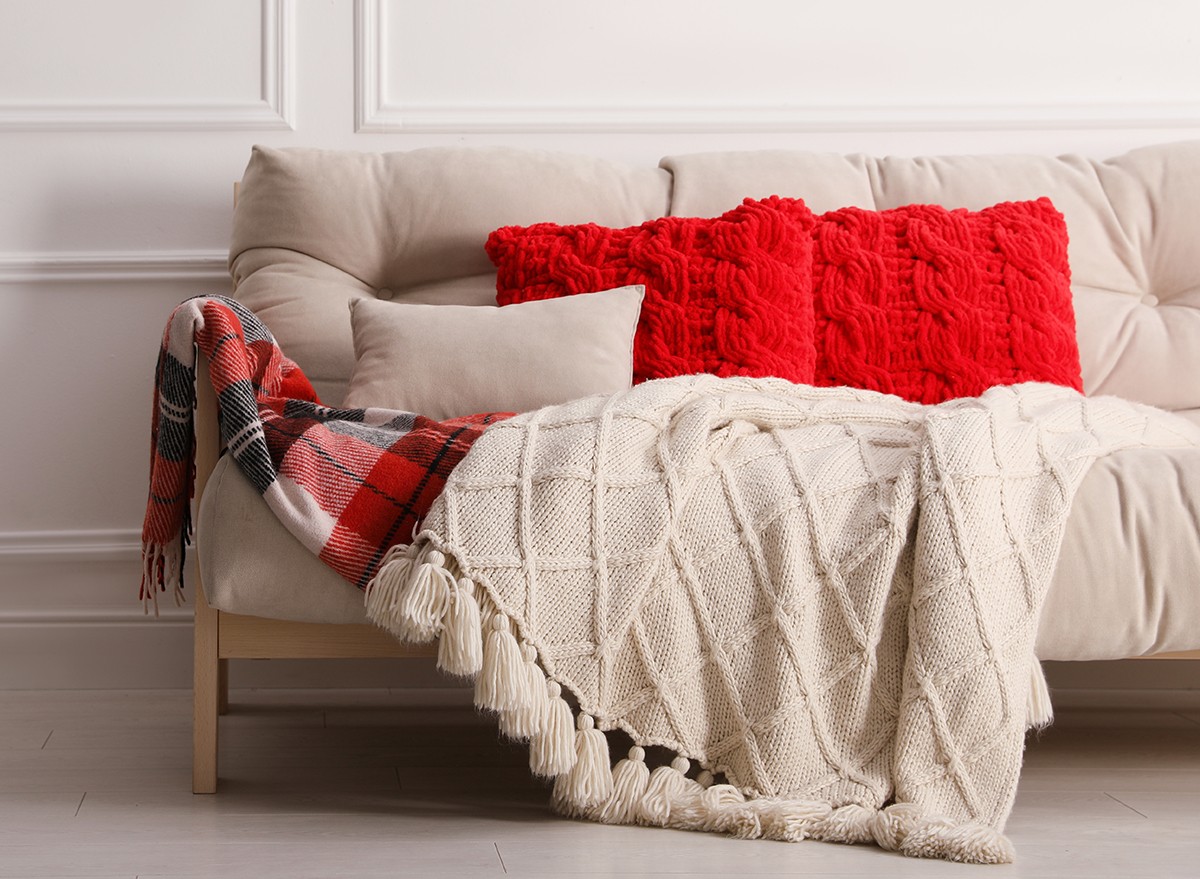 Textured blanket, a plaid throw and pillows on a couch