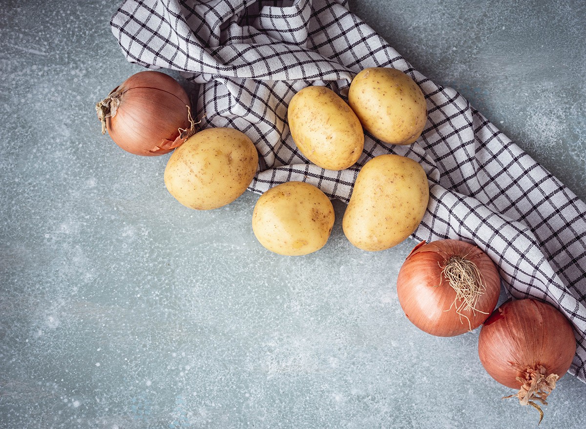Potatoes and onions on a kitchen counter