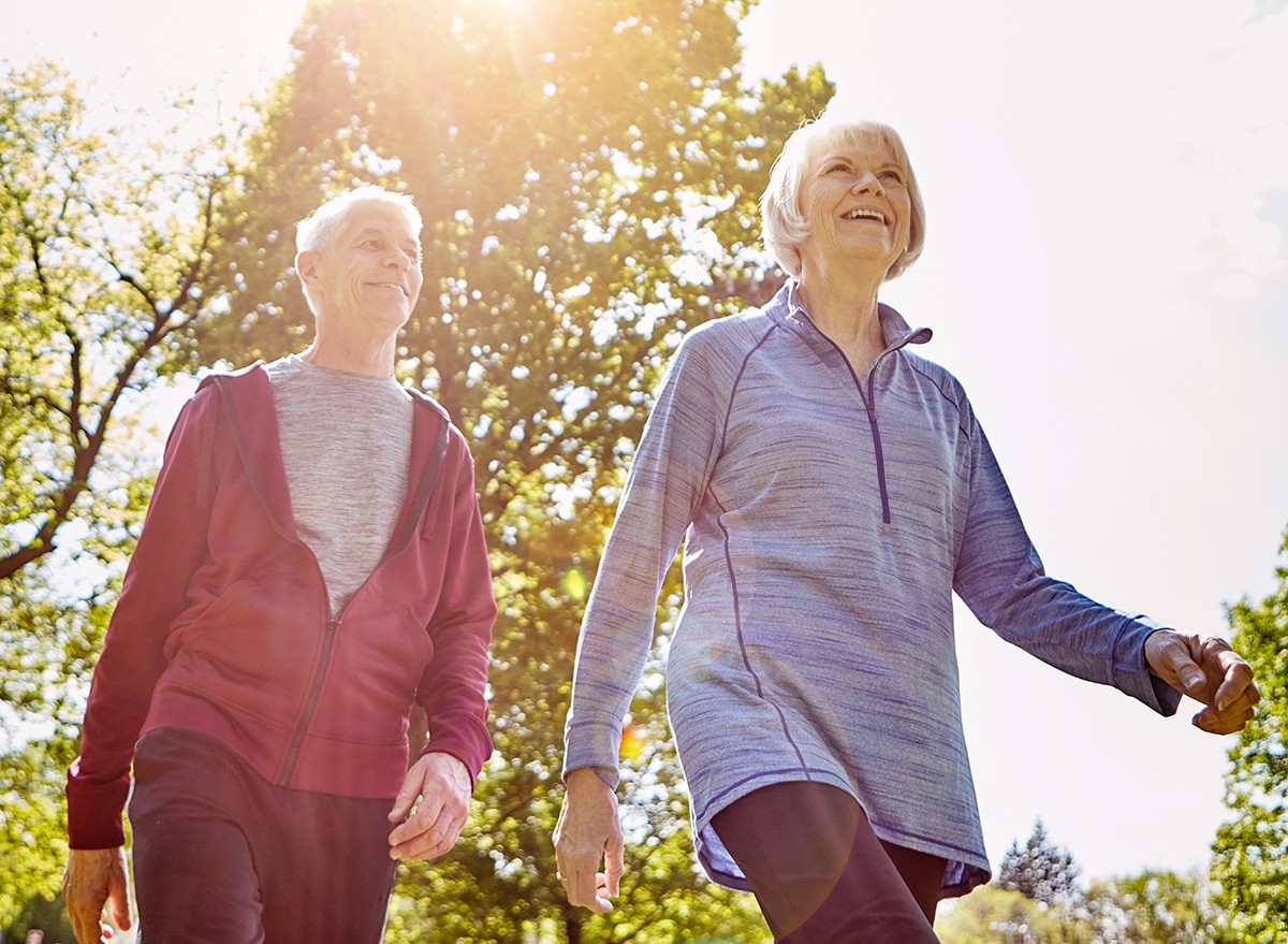 A mature couple walking in the sunshine
