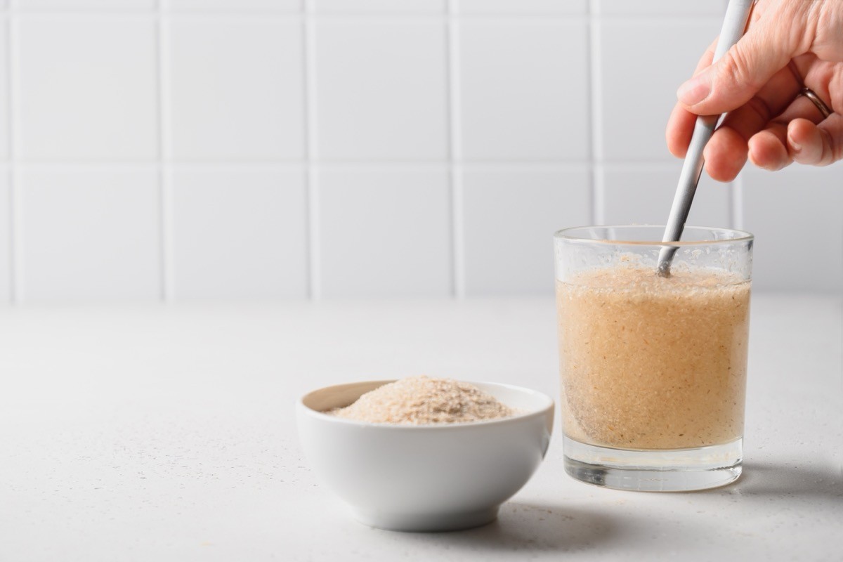 Woman adding psyllium fiber to water
