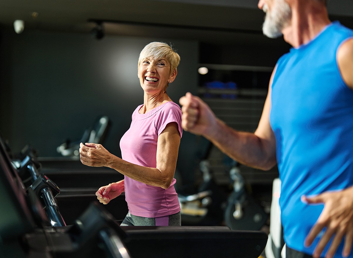 A senior couple on the treadmills at the gym