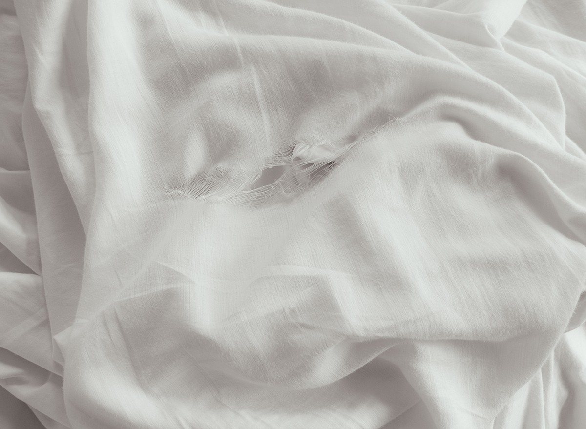 Torn bedsheets that need replacing