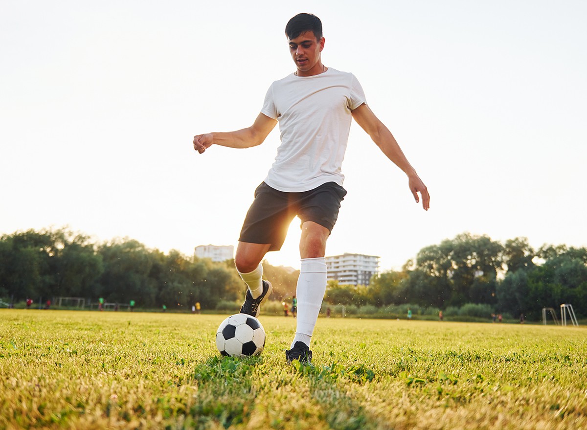 A man playing soccer on a field
