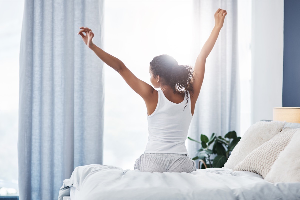 woman stretching after she wakes up in the morning