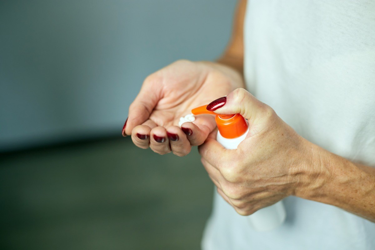 A woman applying moisturizing hand cream
