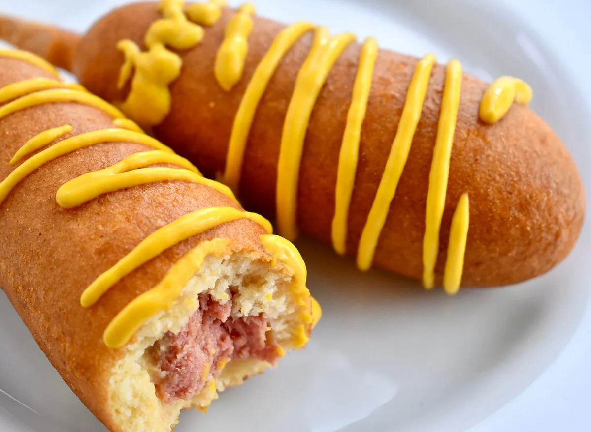 Two cooked corn dogs on a plate