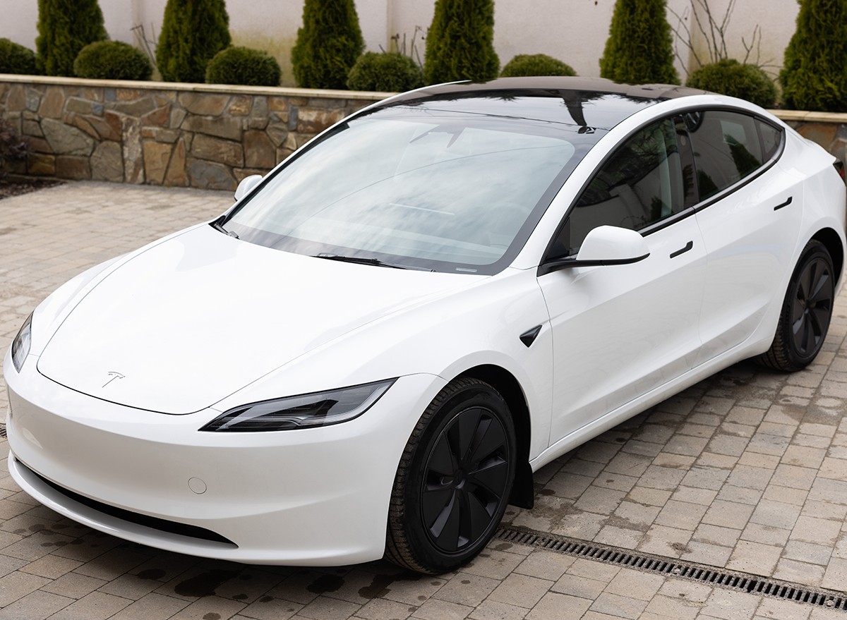 White Tesla Model 3 highland electric car in showroom