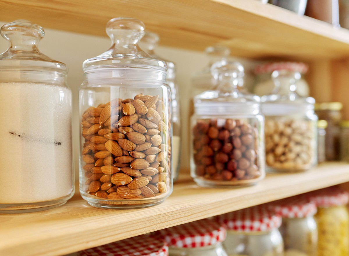 Nuts in glass jars on a pantry shelf