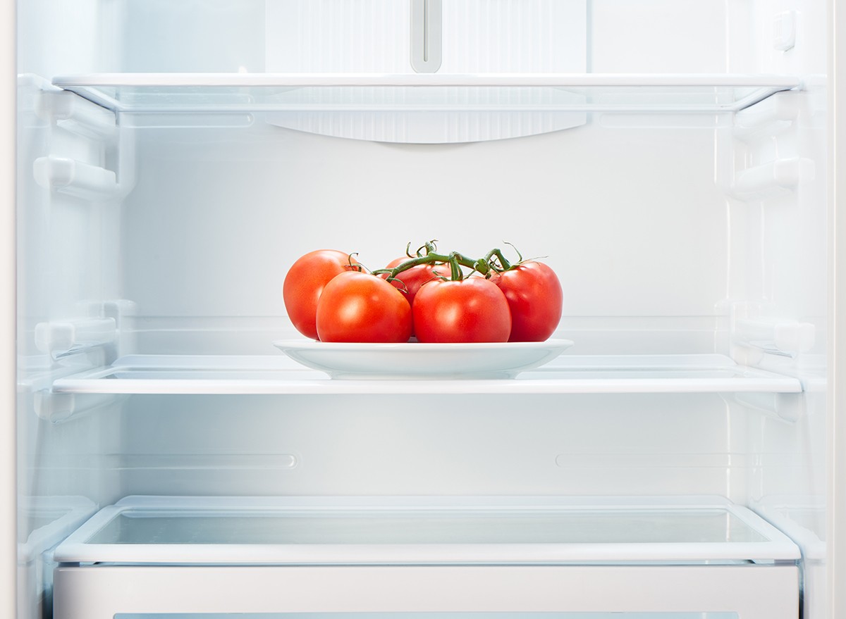 Tomatoes on a plate on a shelf in a fridge