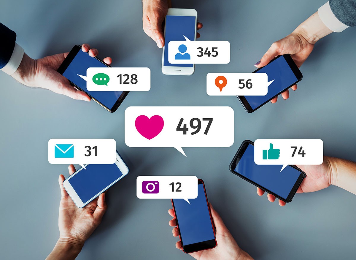 Hands holding mobile phones with social media comments