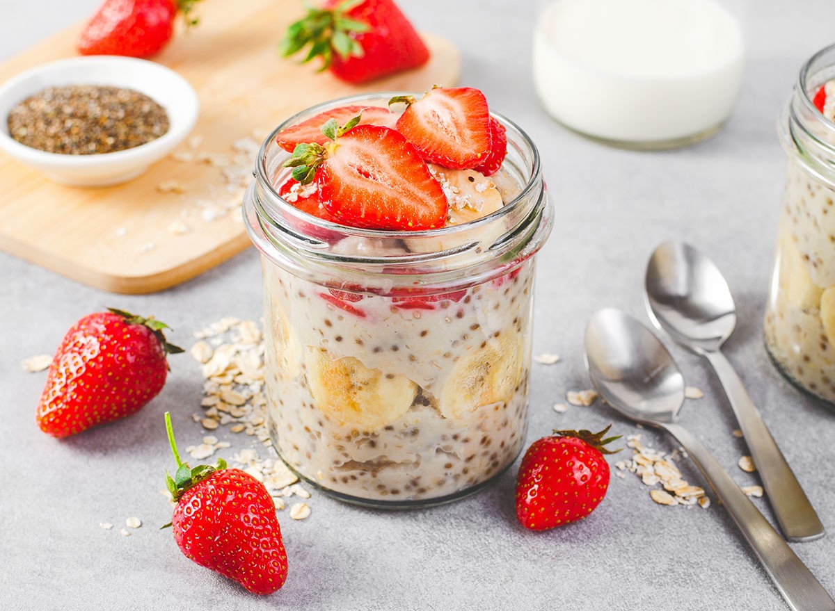 Overnight oats in a glass jar with fresh strawberries.
