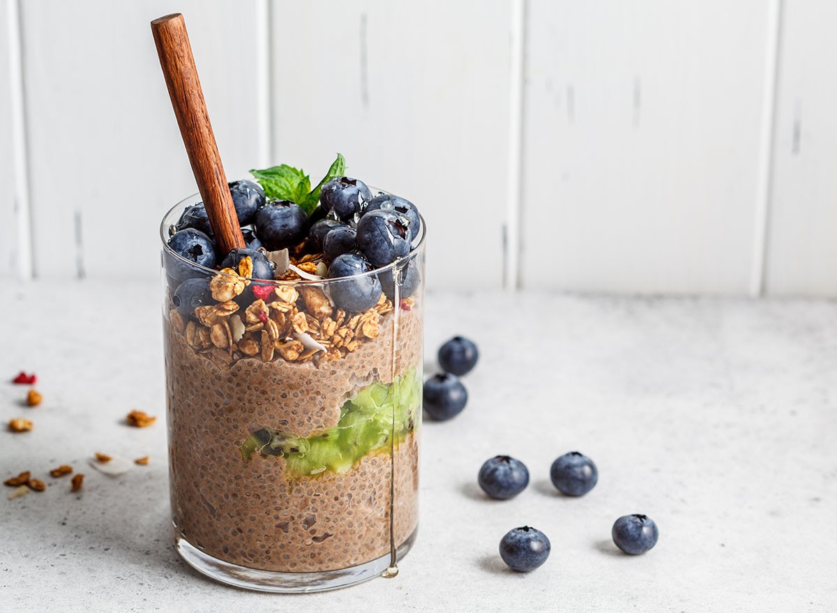 Chocolate chia pudding in a glass topped with blueberries