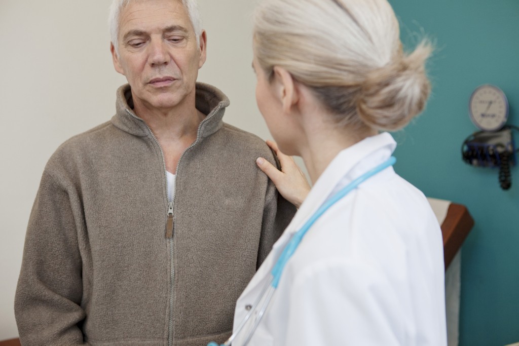 doctor comforting man