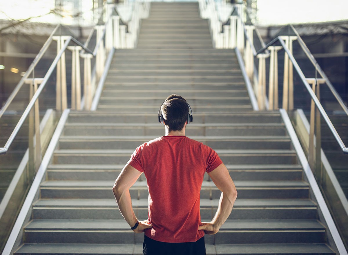 Man looking up at stairs before climbing