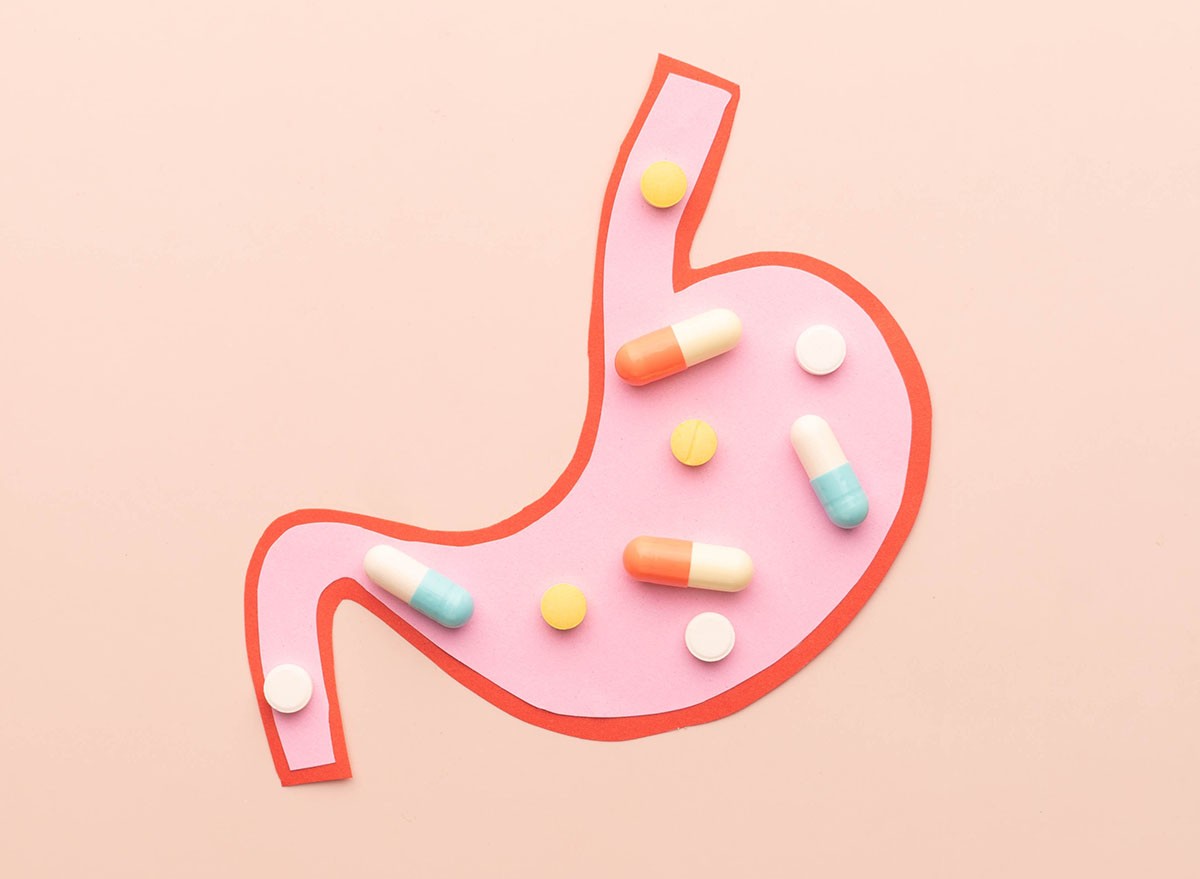 Stomach organ with PPl medication on beige background