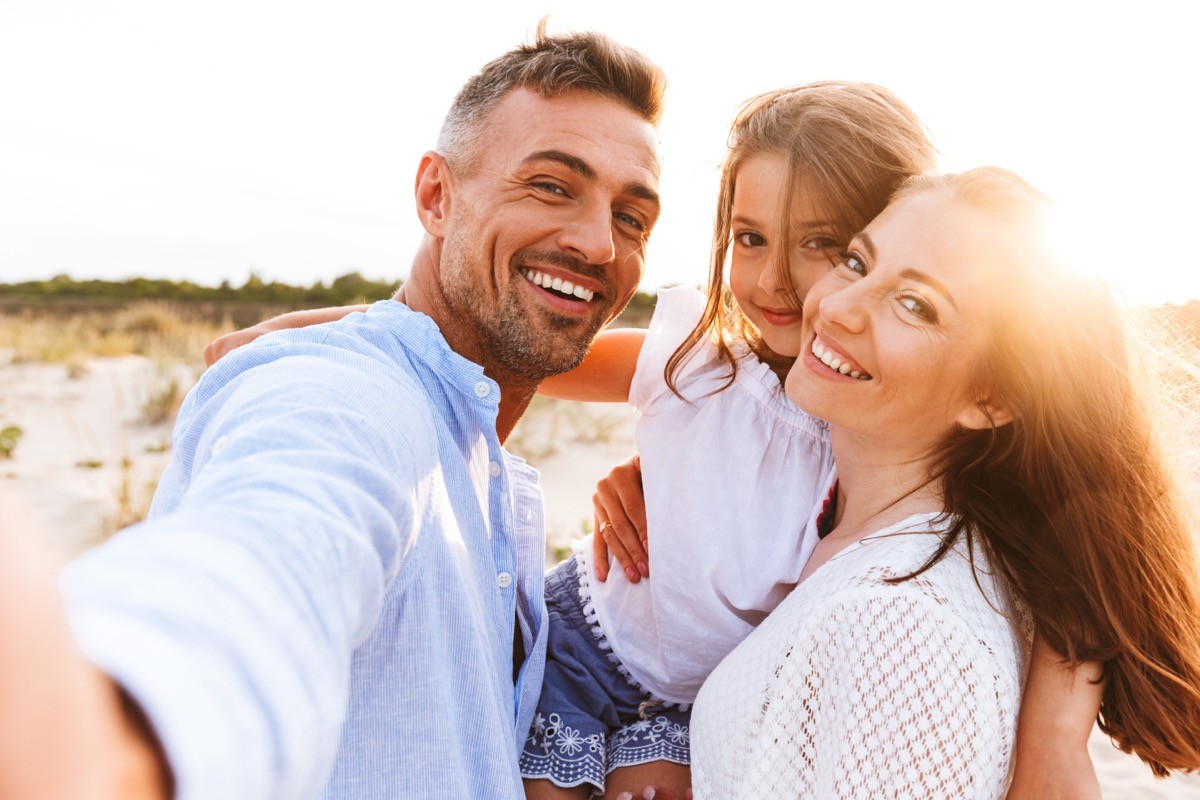 A family at the beach in the sunshine