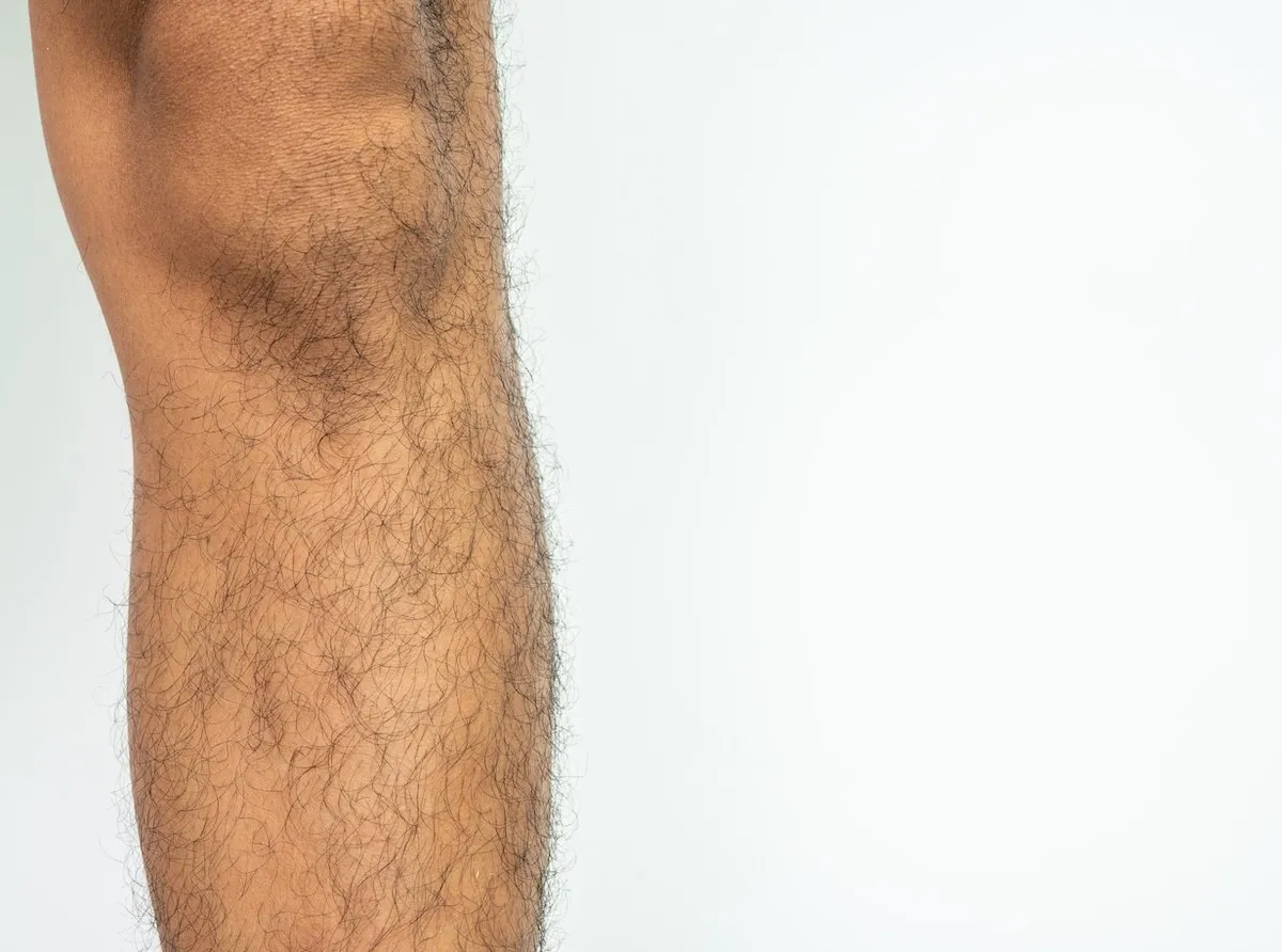 closeup of a man's shin with leg hair