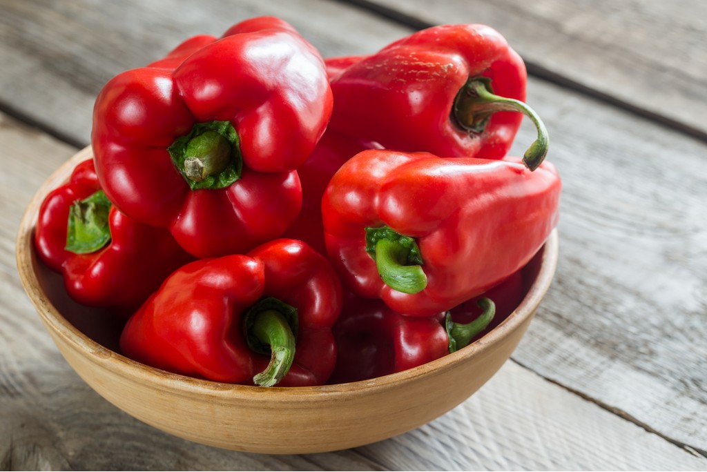 Red Bell Peppers in a wooden bowl