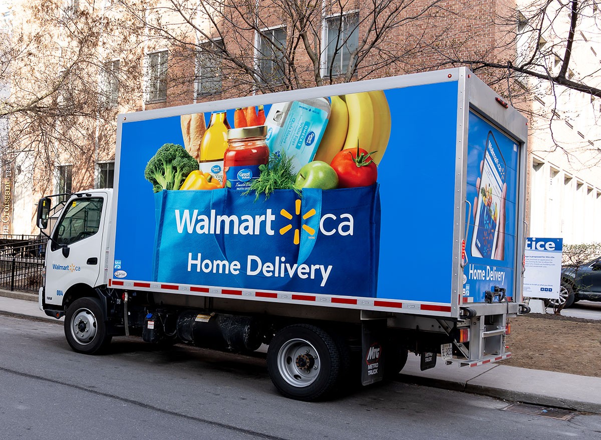 A Walmart home delivery truck parked on the street