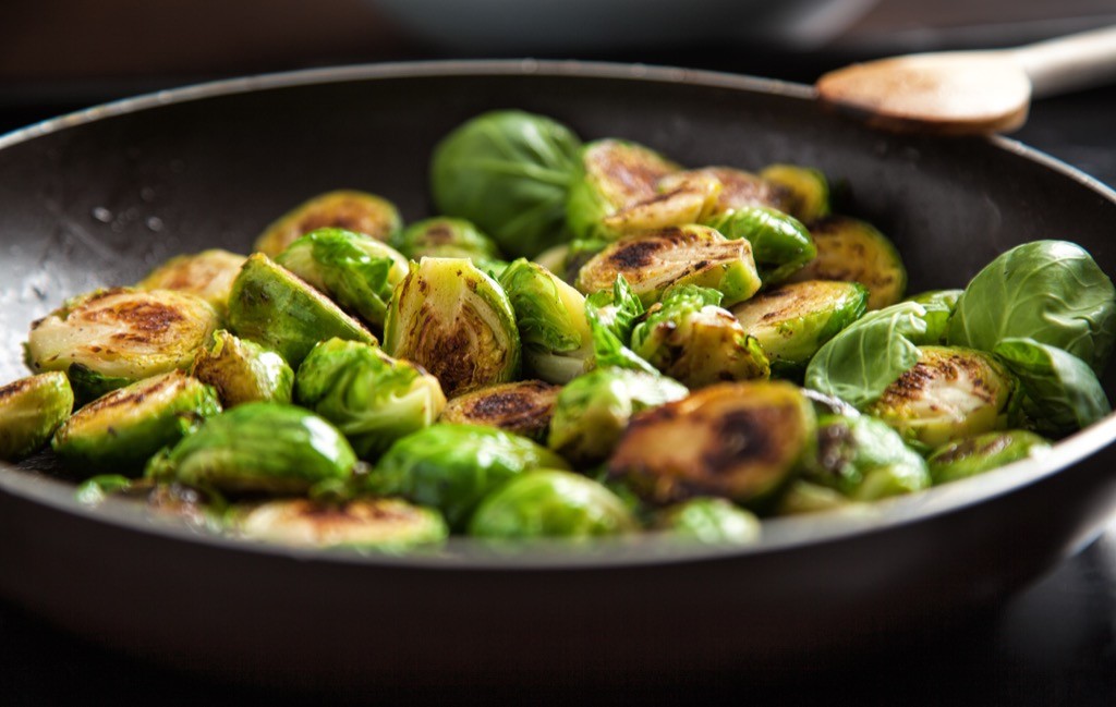 Brussels sprouts being sautéed in a pan