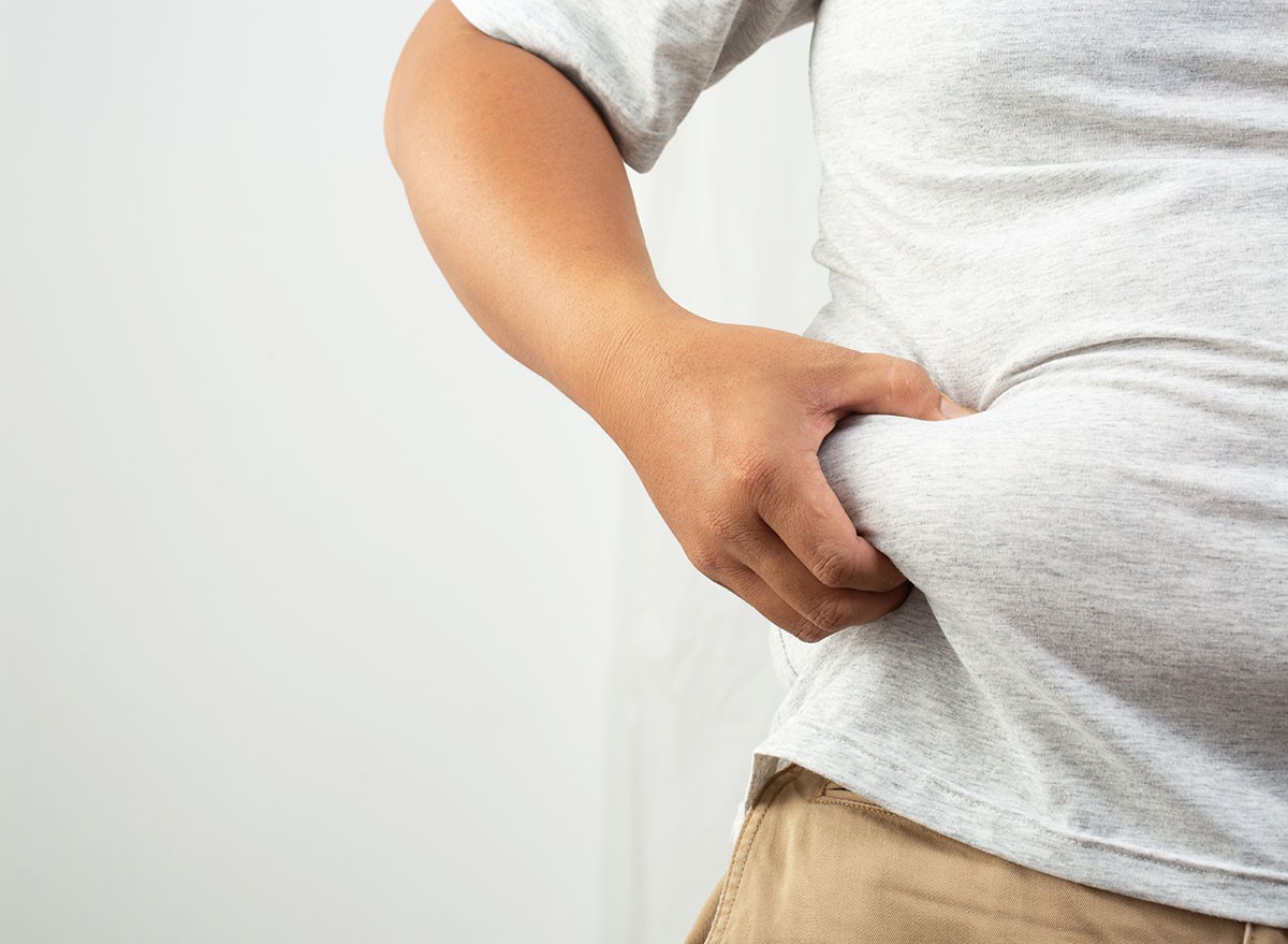 closeup of a man grabbing his belly fat