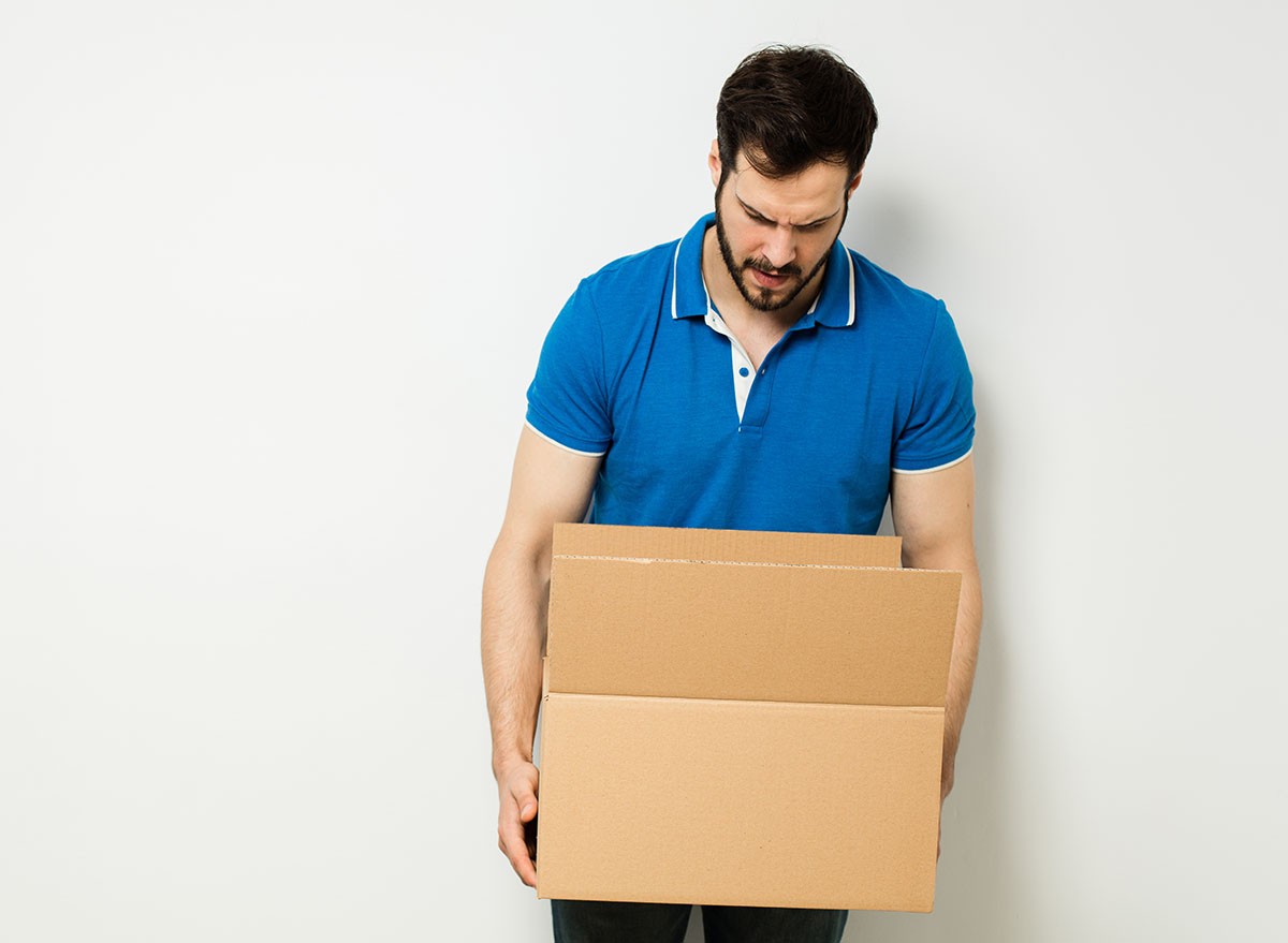 A man looking intently at the contents of a box