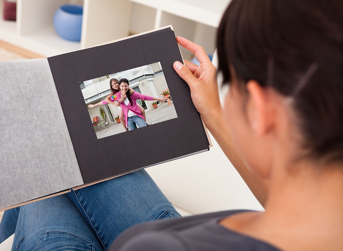 A woman looking through an album of photographs