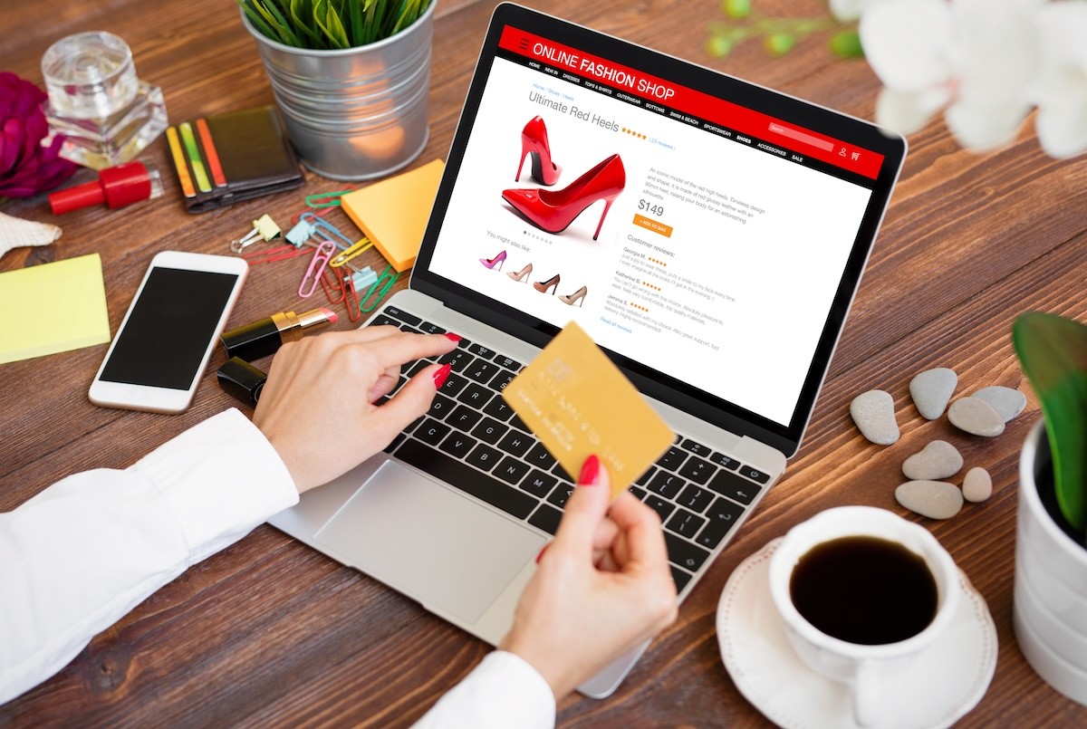 woman using credit card to buy shoes online